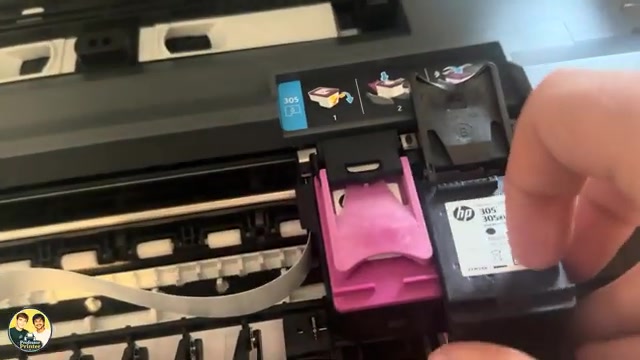 Source view of the separate tri-color and black cartridge holders, with the black latch open as the cartridge is inserted.